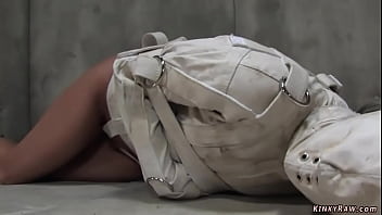 Sexy tanned brunette psycho India Summer is tied in white straitjacket and hooded then master takes off her hood and gags her with ball